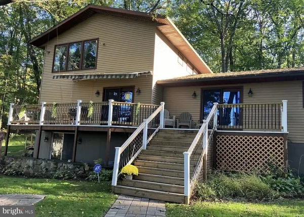 a view of house and outdoor space with a roof deck