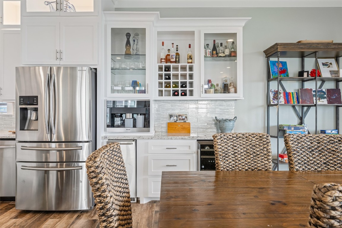 3116 James Street Crystal Beach, TX 77650 - Photo 19 of 47 a kitchen with stainless steel appliances wooden floor and a refrigerator