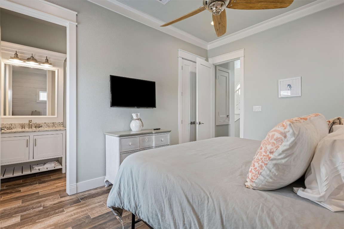 3116 James Street Crystal Beach, TX 77650 - Photo 26 of 47 a bedroom with a bed and a flat tv screen on dresser