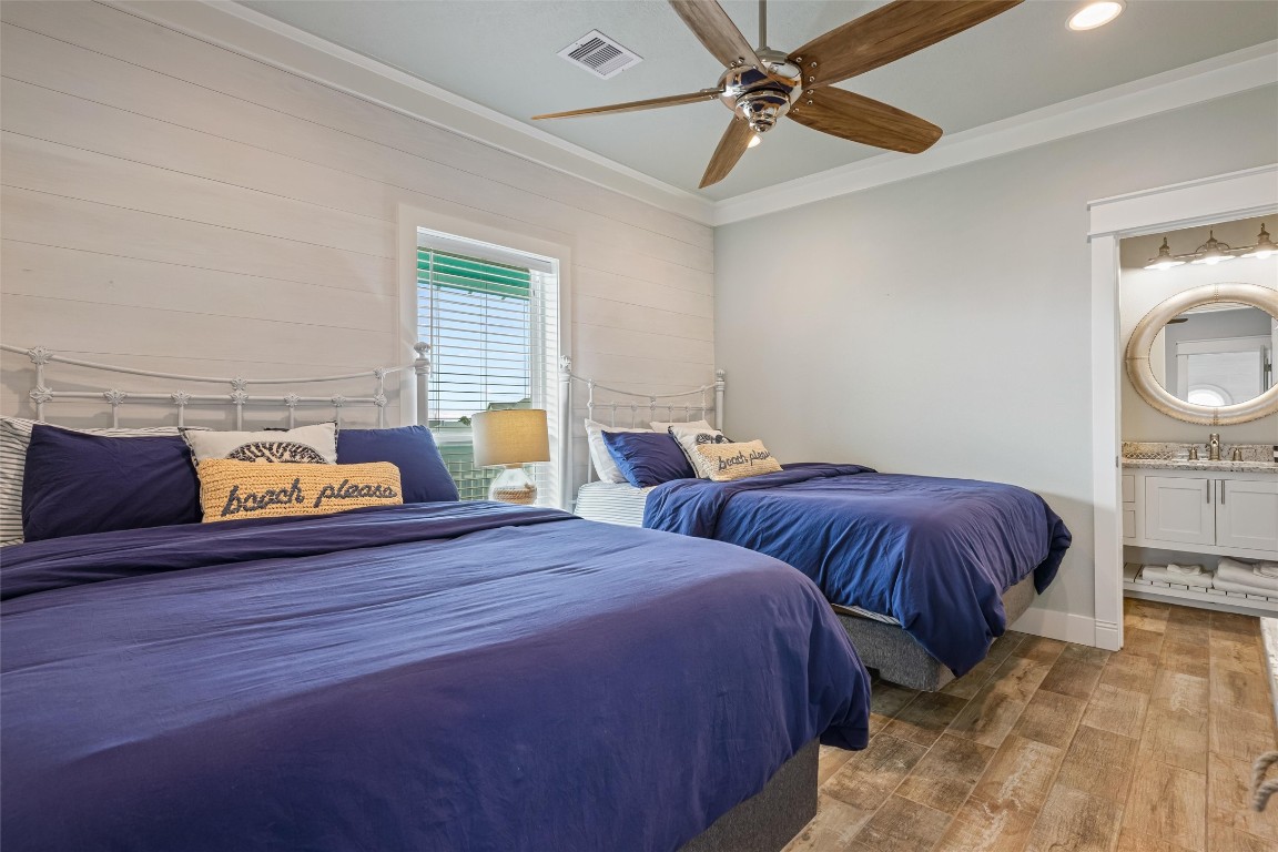 3116 James Street Crystal Beach, TX 77650 - Photo 35 of 47 a bedroom with two beds and painting on the wall