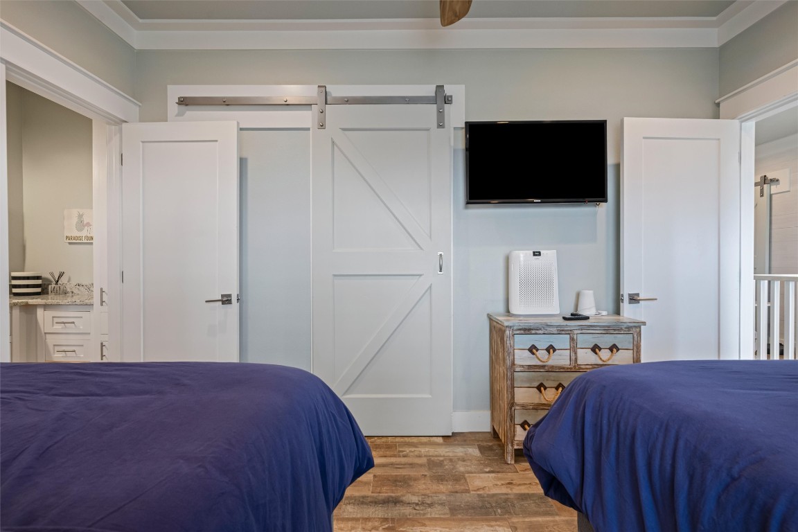 3116 James Street Crystal Beach, TX 77650 - Photo 36 of 47 a bedroom with a bed and a flat tv screen