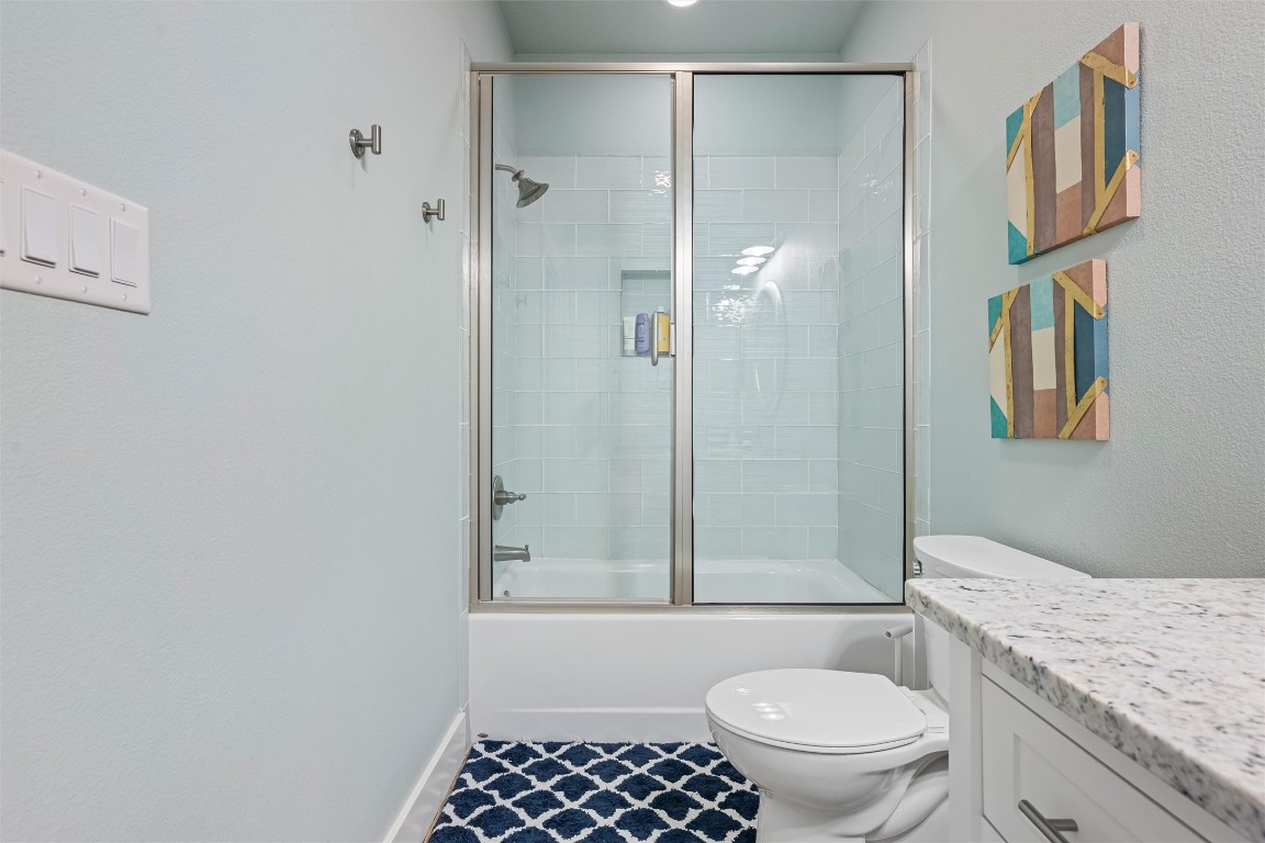 3116 James Street Crystal Beach, TX 77650 - Photo 38 of 47 a bathroom with a granite countertop sink toilet and shower
