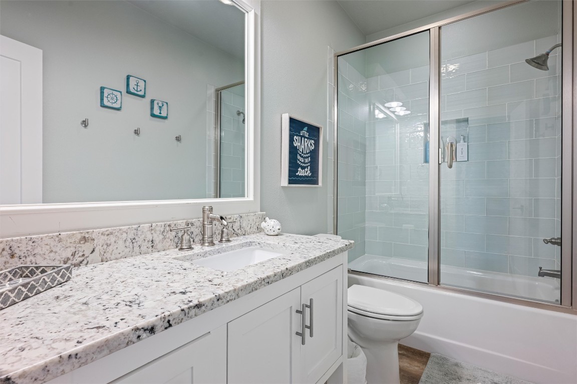 3116 James Street Crystal Beach, TX 77650 - Photo 41 of 47 a bathroom with a granite countertop sink toilet and shower