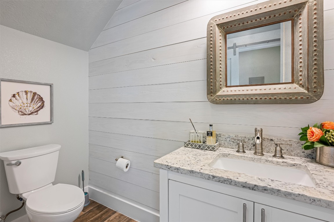 3116 James Street Crystal Beach, TX 77650 - Photo 43 of 47 a bathroom with a granite countertop toilet sink and mirror