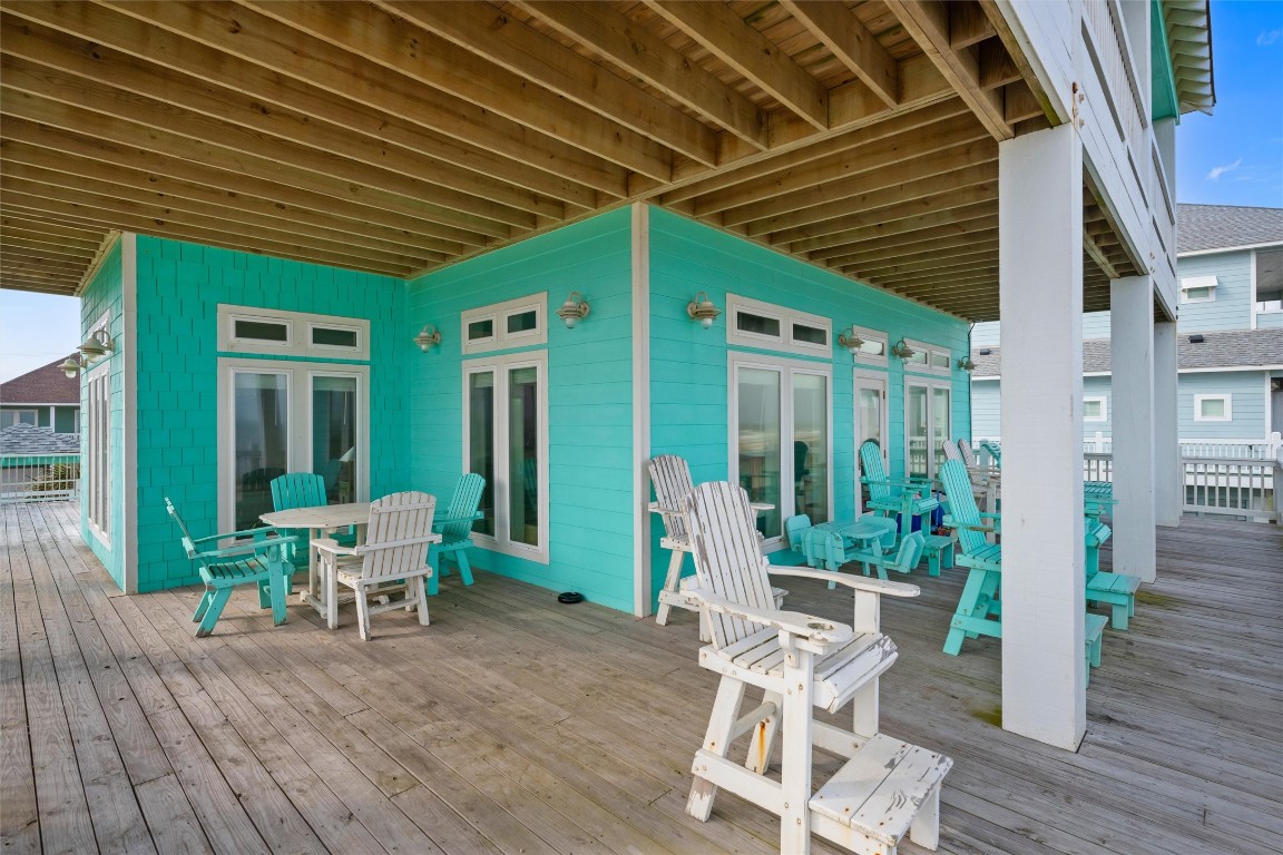 3116 James Street Crystal Beach, TX 77650 - Photo 7 of 47 a view of a patio with table and chairs and wooden floor