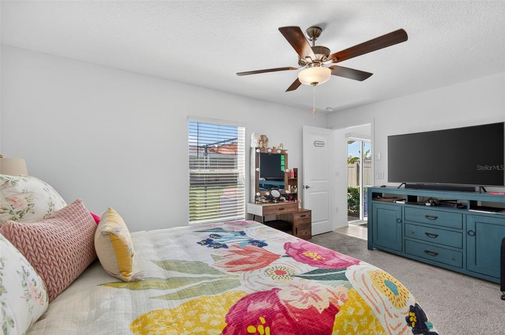 11120 Radiant Shore Loop San Antonio, FL 33576 - Photo 3 of 17 a bedroom with a bed and a flat screen tv