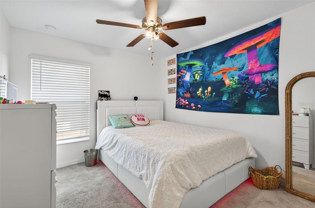 11120 Radiant Shore Loop San Antonio, FL 33576 - Photo 5 of 17 a bedroom with a bed painting on the wall and a large window