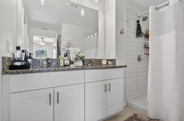 a bathroom with a double vanity sink and mirror