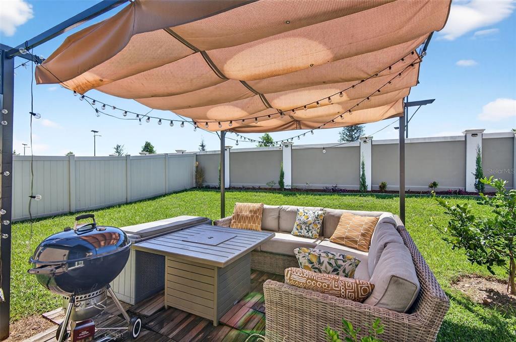 11120 Radiant Shore Loop San Antonio, FL 33576 - Photo 10 of 17 a view of an outdoor sitting area with furniture and umbrella