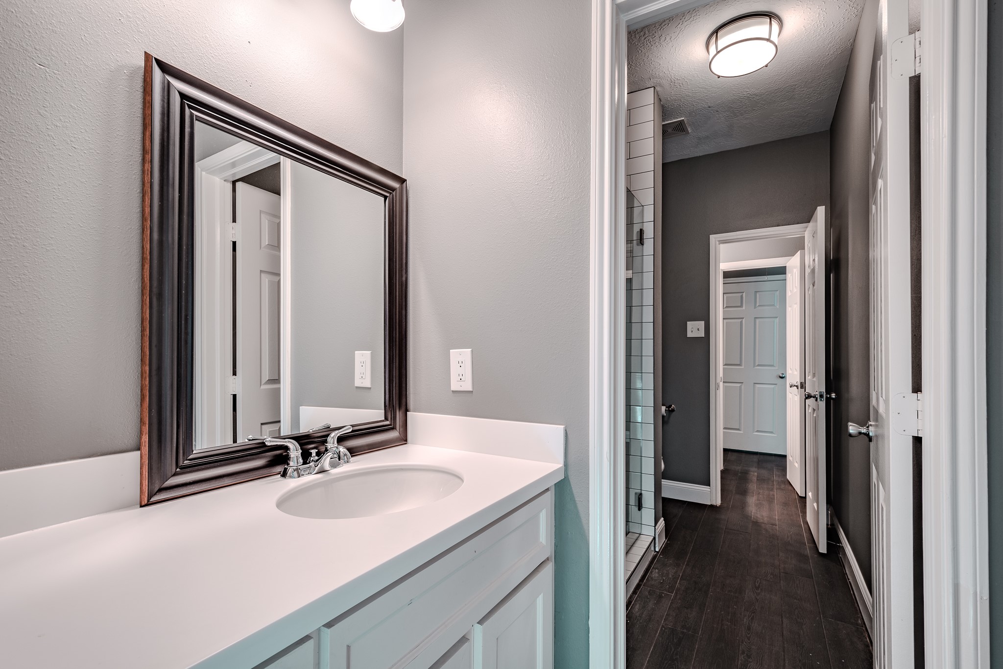 8515 Holly Spring Lane Baytown, TX 77523 - Photo 21 of 28 a bathroom with a sink vanity and mirror