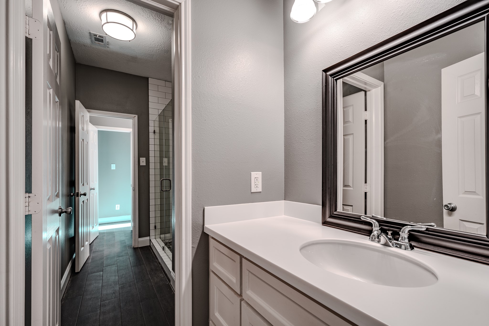 8515 Holly Spring Lane Baytown, TX 77523 - Photo 22 of 28 a en suite bathroom with a sink and a mirror