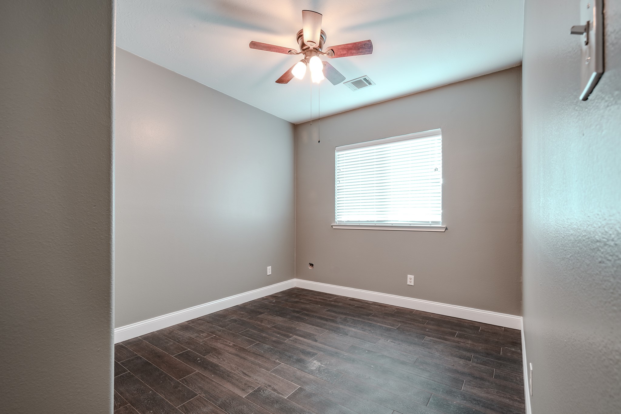 8515 Holly Spring Lane Baytown, TX 77523 - Photo 23 of 28 an empty room with windows and fan