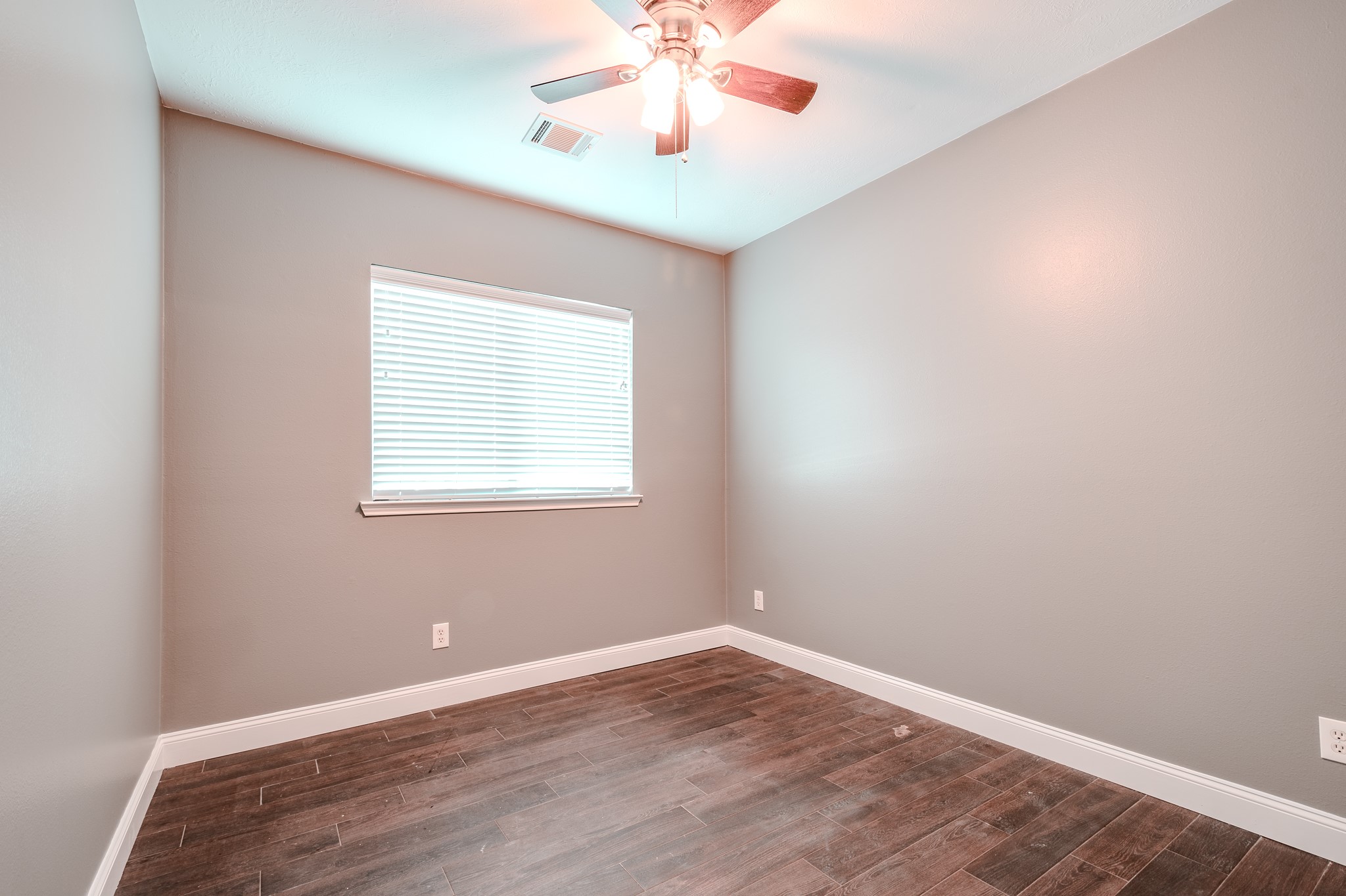 8515 Holly Spring Lane Baytown, TX 77523 - Photo 24 of 28 an empty room with a window and a chandelier fan