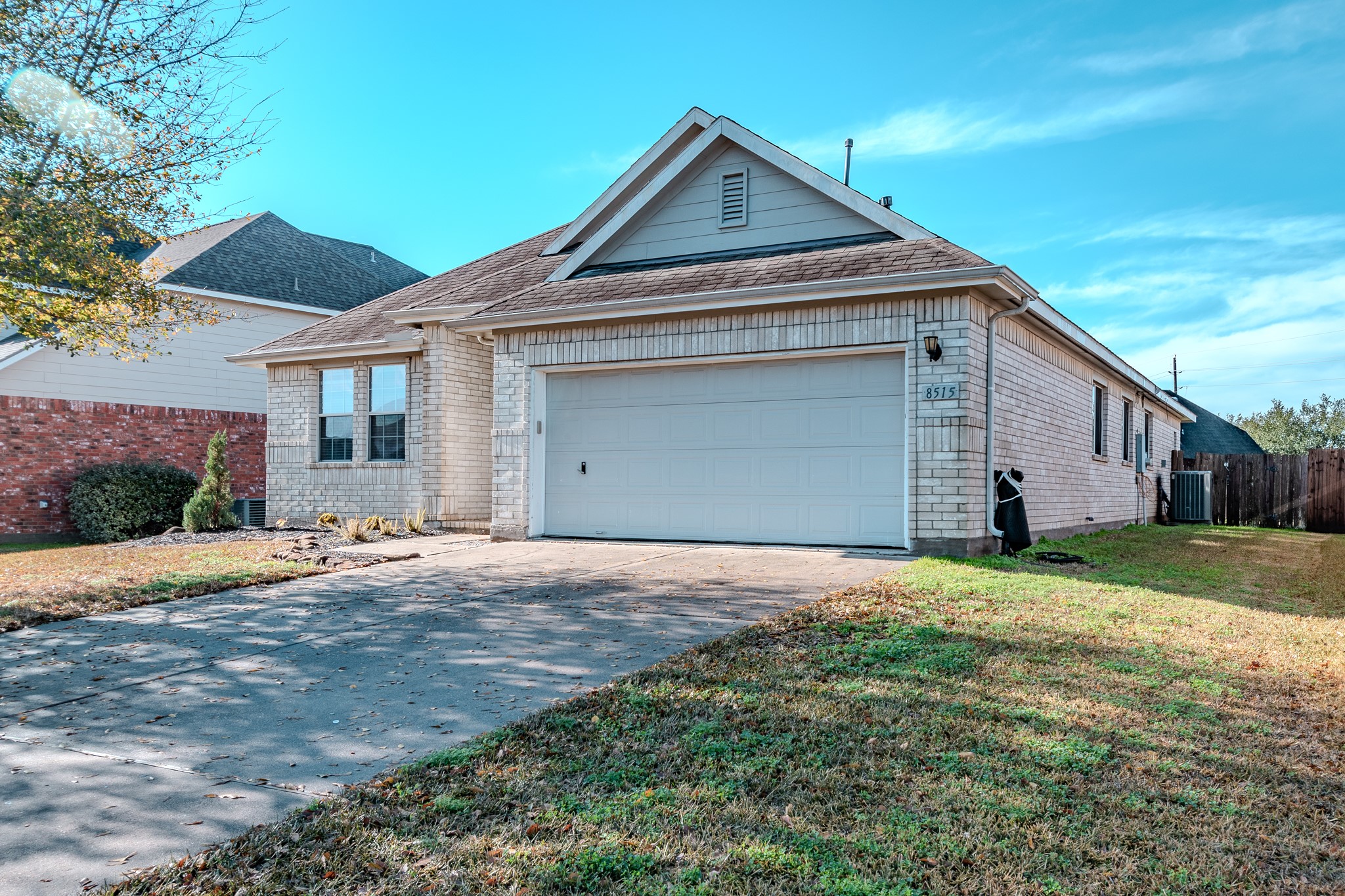 8515 Holly Spring Lane Baytown, TX 77523 - Photo 3 of 28 a front view of a house with a yard and garage
