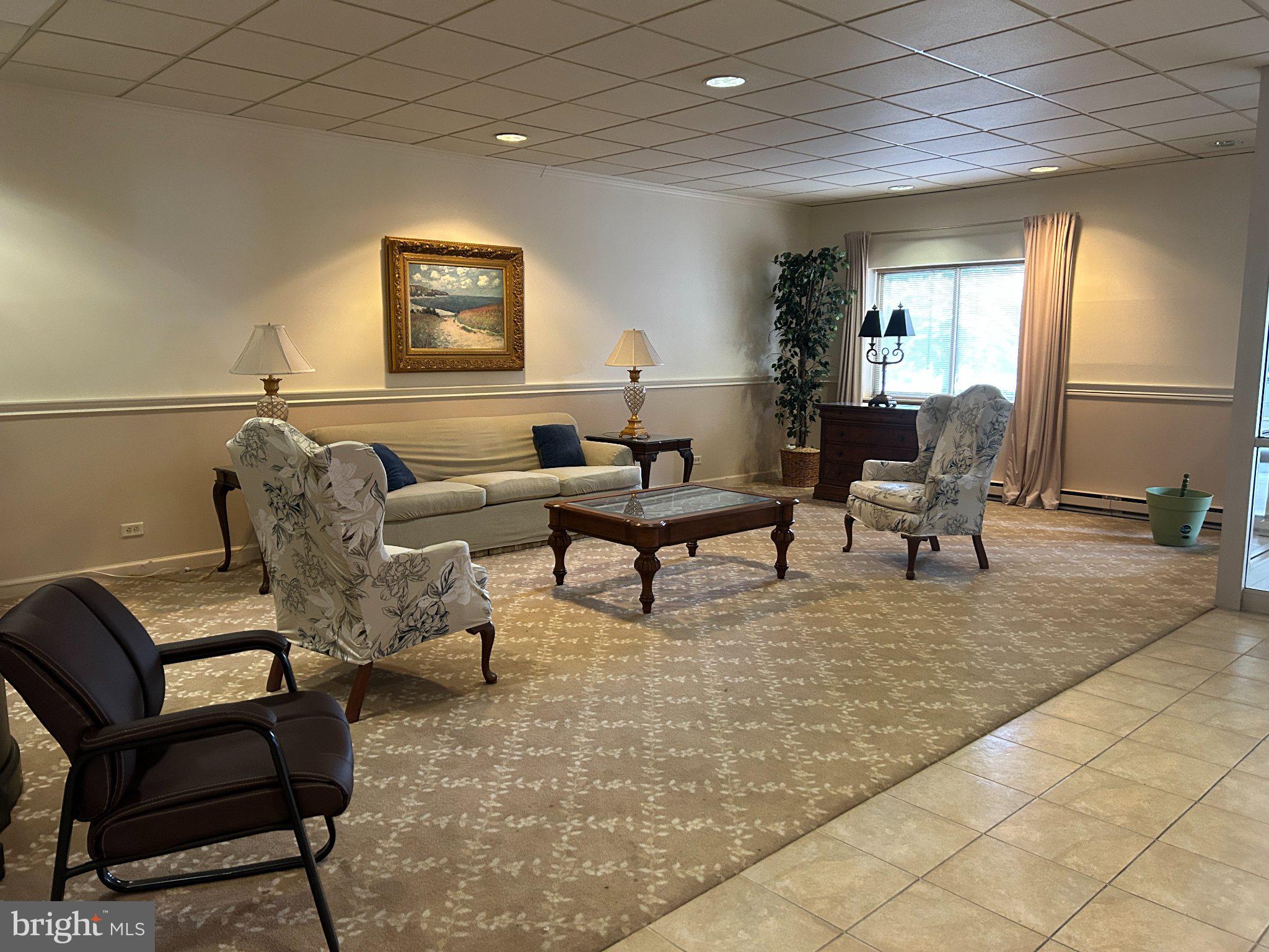 860 Lower Ferry Road, Unit 6M Ewing, NJ 08628 - Photo 3 of 16 a living room with furniture and a painting on the wall
