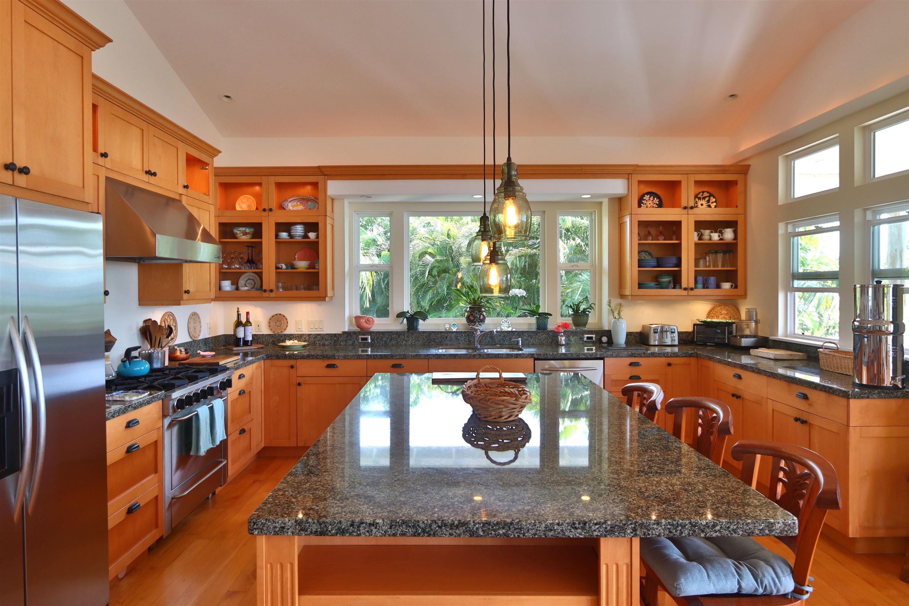 14 Lower Ulumalu Road Haiku, HI 96708 - Photo 14 of 50 a kitchen with stainless steel appliances granite countertop a stove a sink and a dining table
