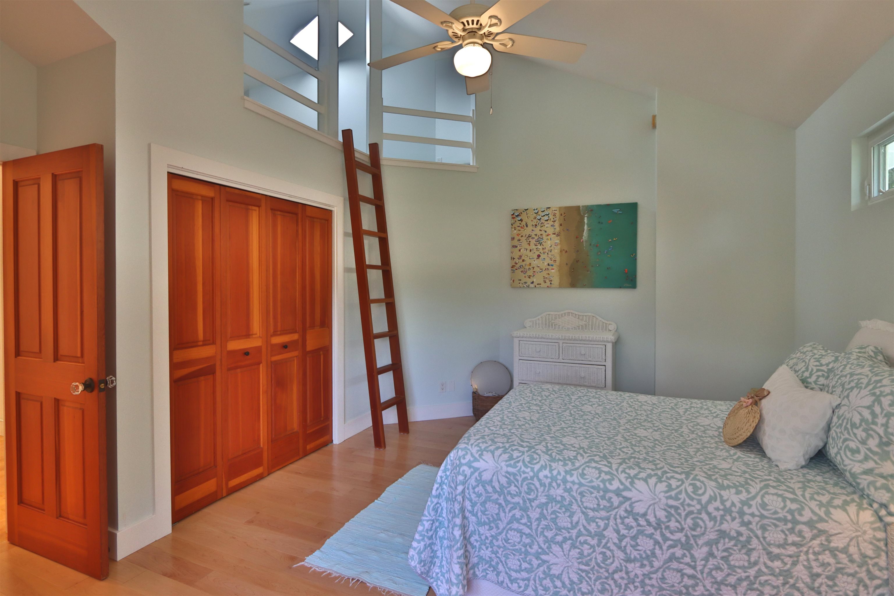 14 Lower Ulumalu Road Haiku, HI 96708 - Photo 28 of 50 a bedroom with a bed and a chandelier