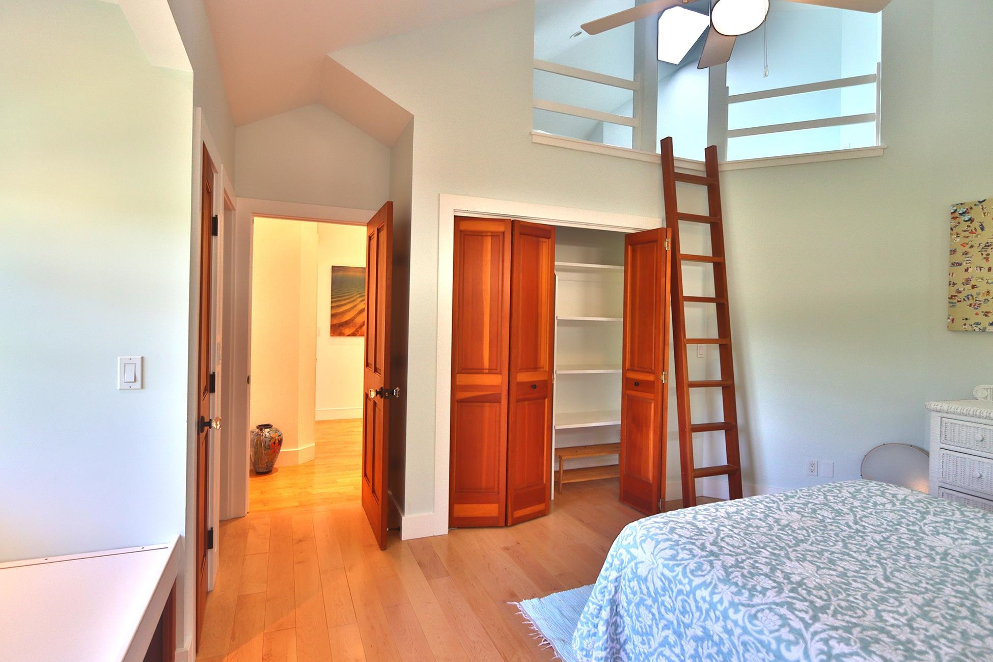 14 Lower Ulumalu Road Haiku, HI 96708 - Photo 32 of 50 a bedroom with a bed and wooden floor