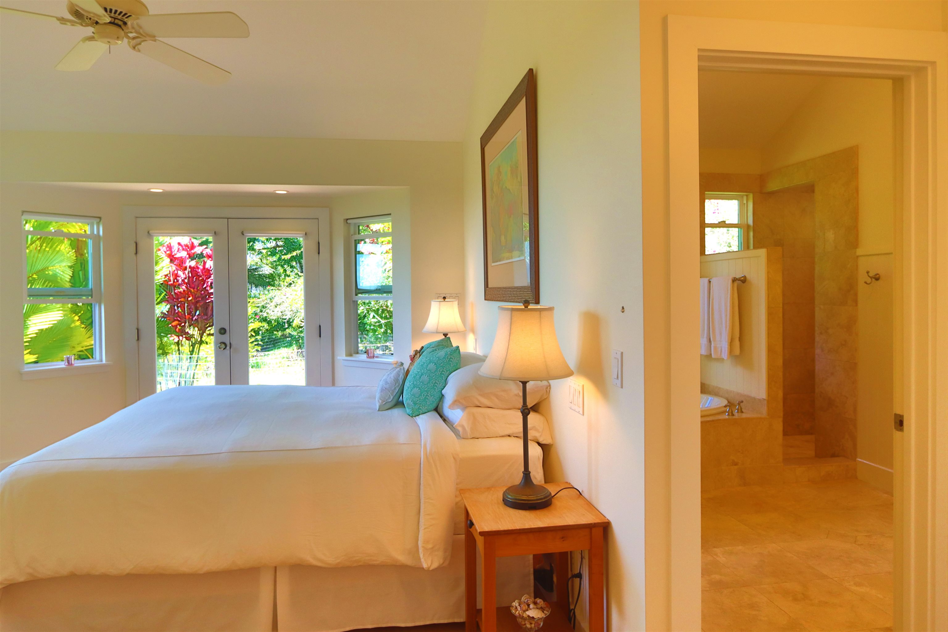 14 Lower Ulumalu Road Haiku, HI 96708 - Photo 34 of 50 a bedroom with a bed and a chandelier