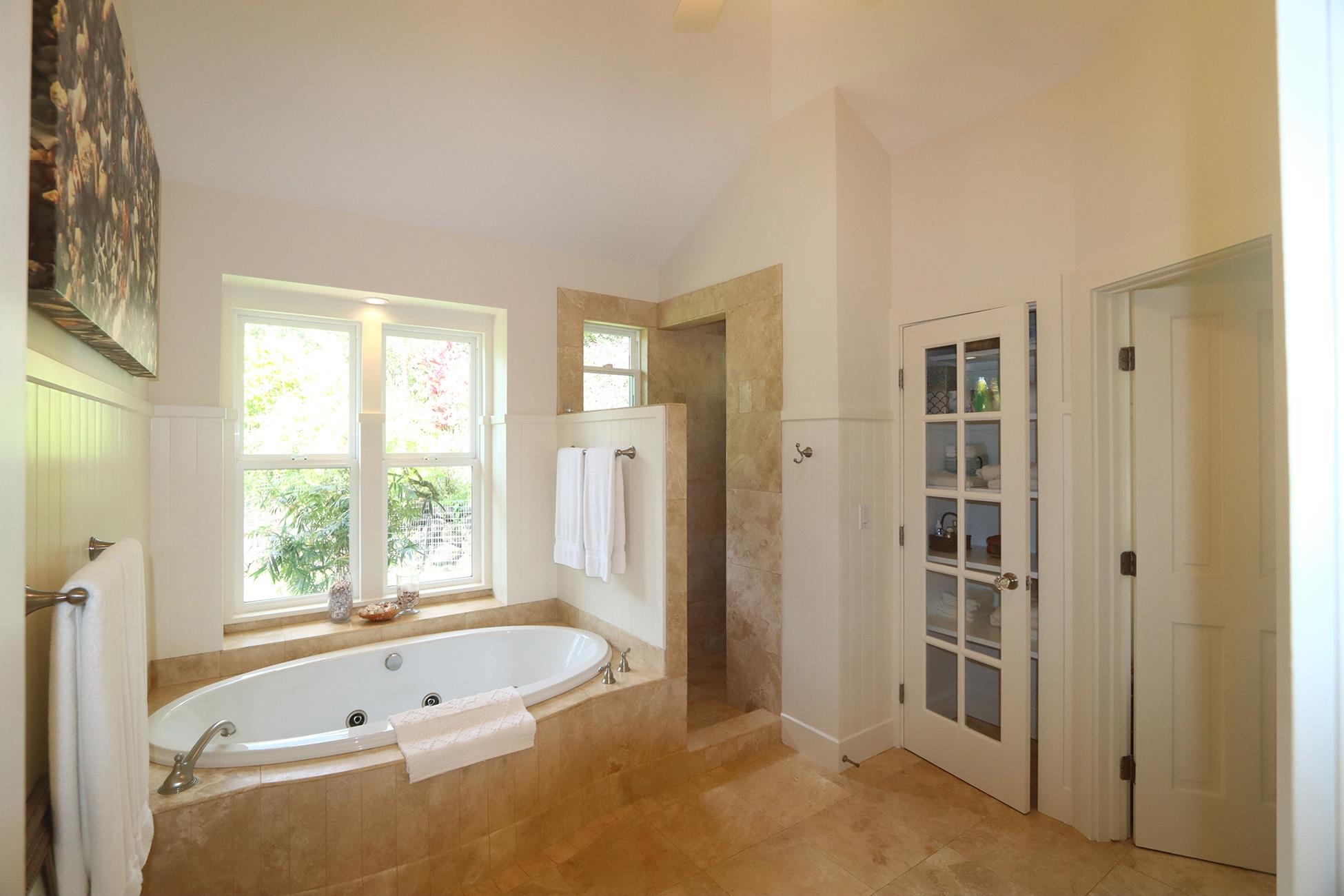 14 Lower Ulumalu Road Haiku, HI 96708 - Photo 36 of 50 a bathroom with a tub shower and windows