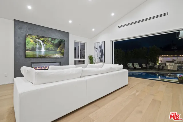 a living room with a flat screen tv a couch and a a coffee table