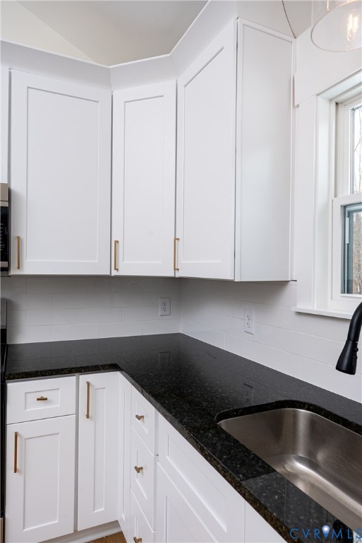 601 Mill Pond Drive Ruther Glen, VA 22546 - Photo 12 of 32 a kitchen with granite countertop white cabinets and sink