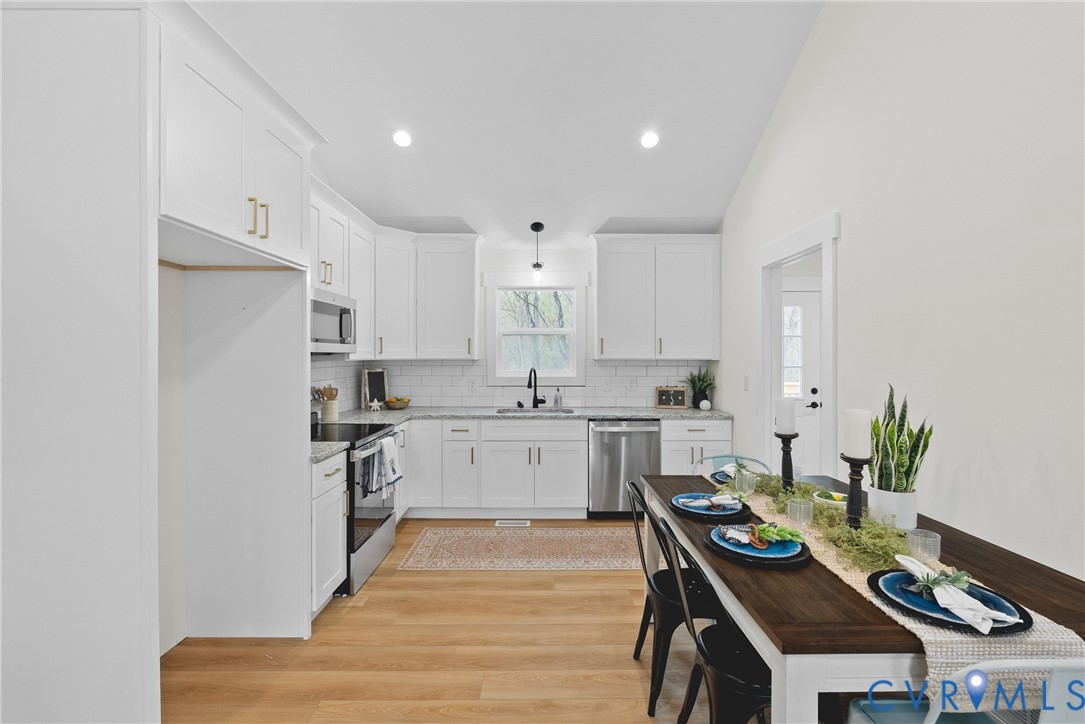 601 Mill Pond Drive Ruther Glen, VA 22546 - Photo 13 of 32 a kitchen with a refrigerator and a stove top oven
