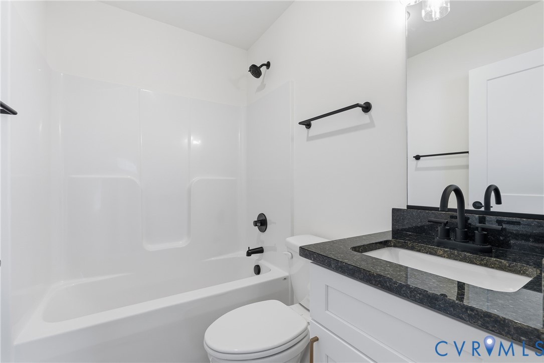 601 Mill Pond Drive Ruther Glen, VA 22546 - Photo 25 of 32 a bathroom with a granite countertop sink toilet and bathtub