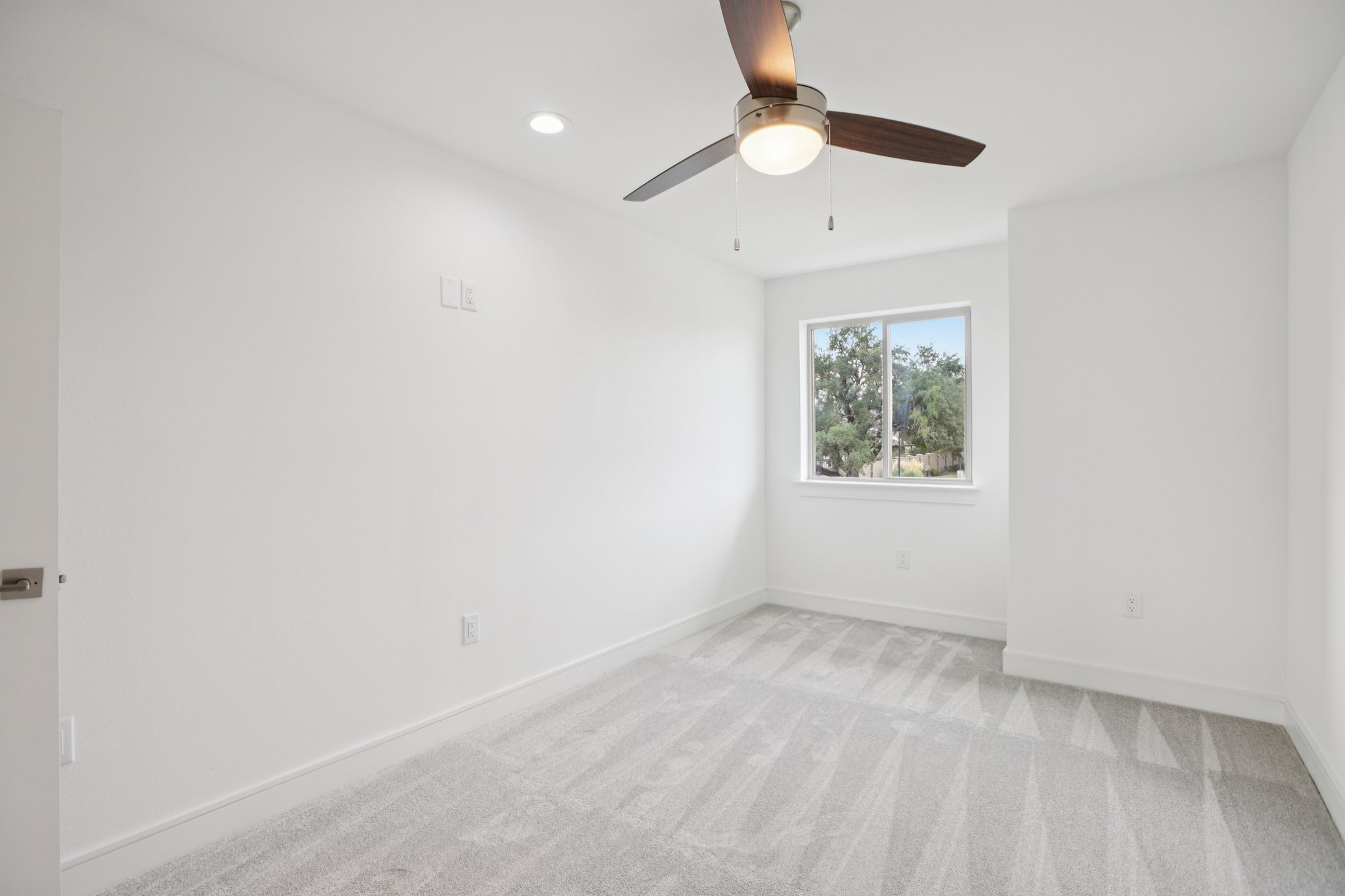 202 Tesla Circle Austin, TX 78681 - Photo 26 of 35 Spare room with light colored carpet, ceiling fan, and recessed lighting