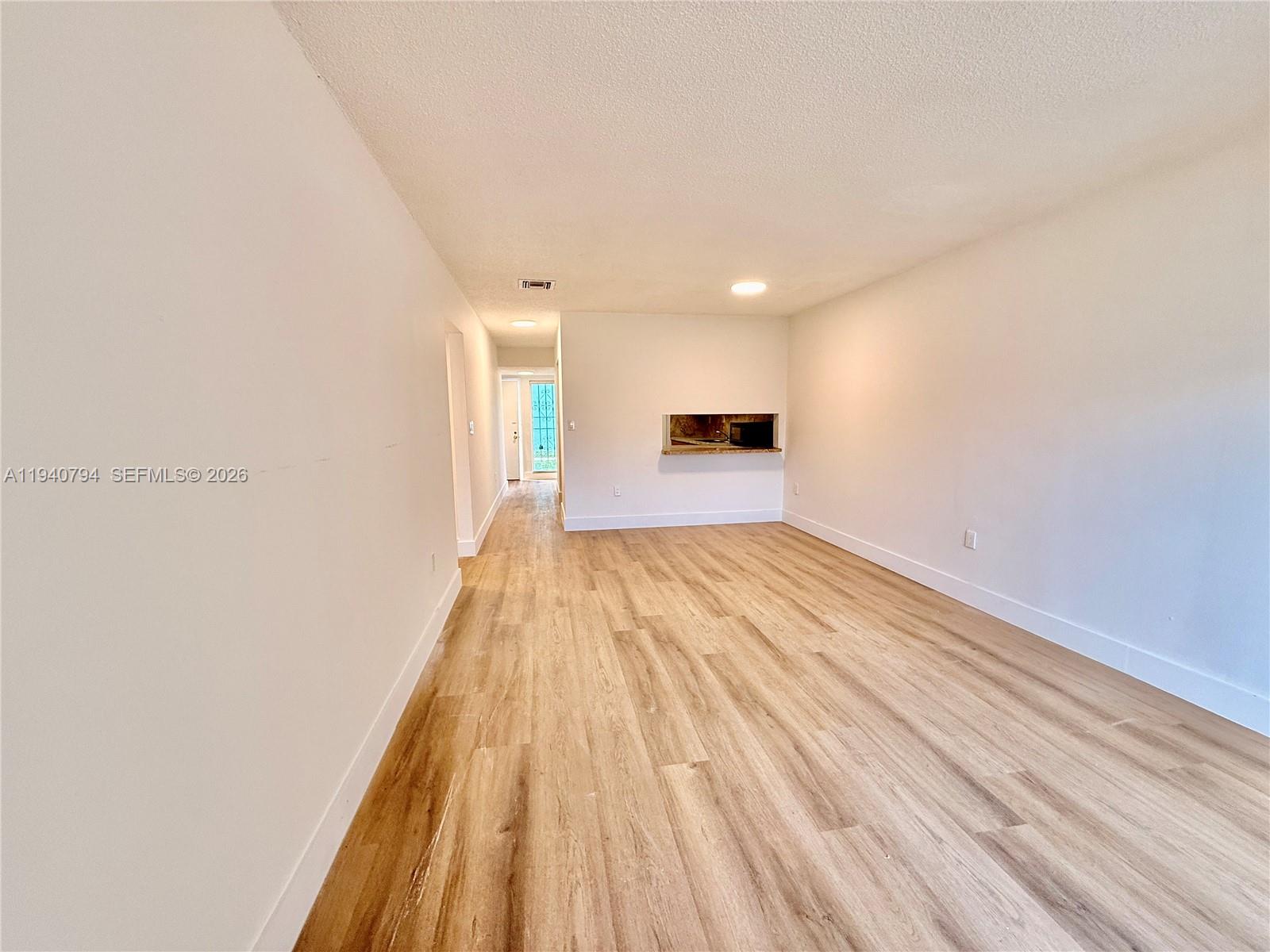 617 Northwest 10th Street Miami, FL 33136 - Photo 12 of 29 a view of a room with wooden floor and fence