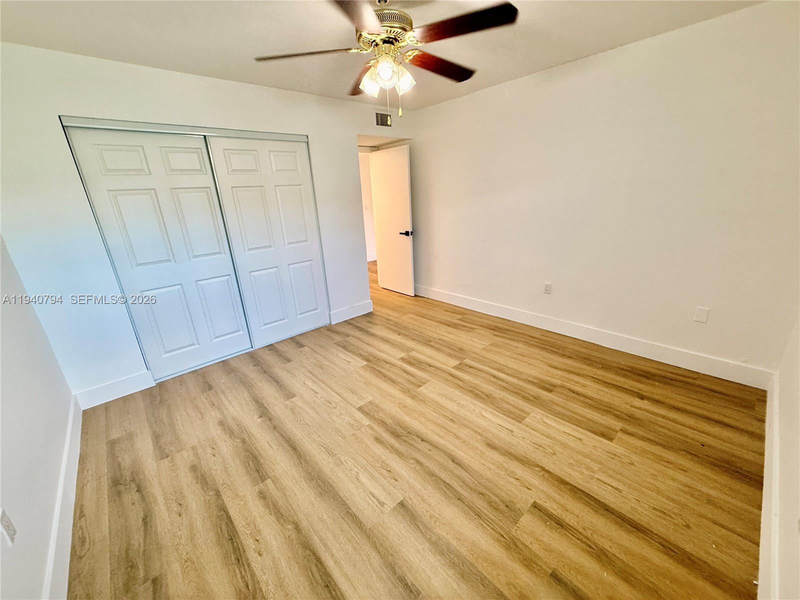617 Northwest 10th Street Miami, FL 33136 - Photo 14 of 29 a view of an empty room with a ceiling fan