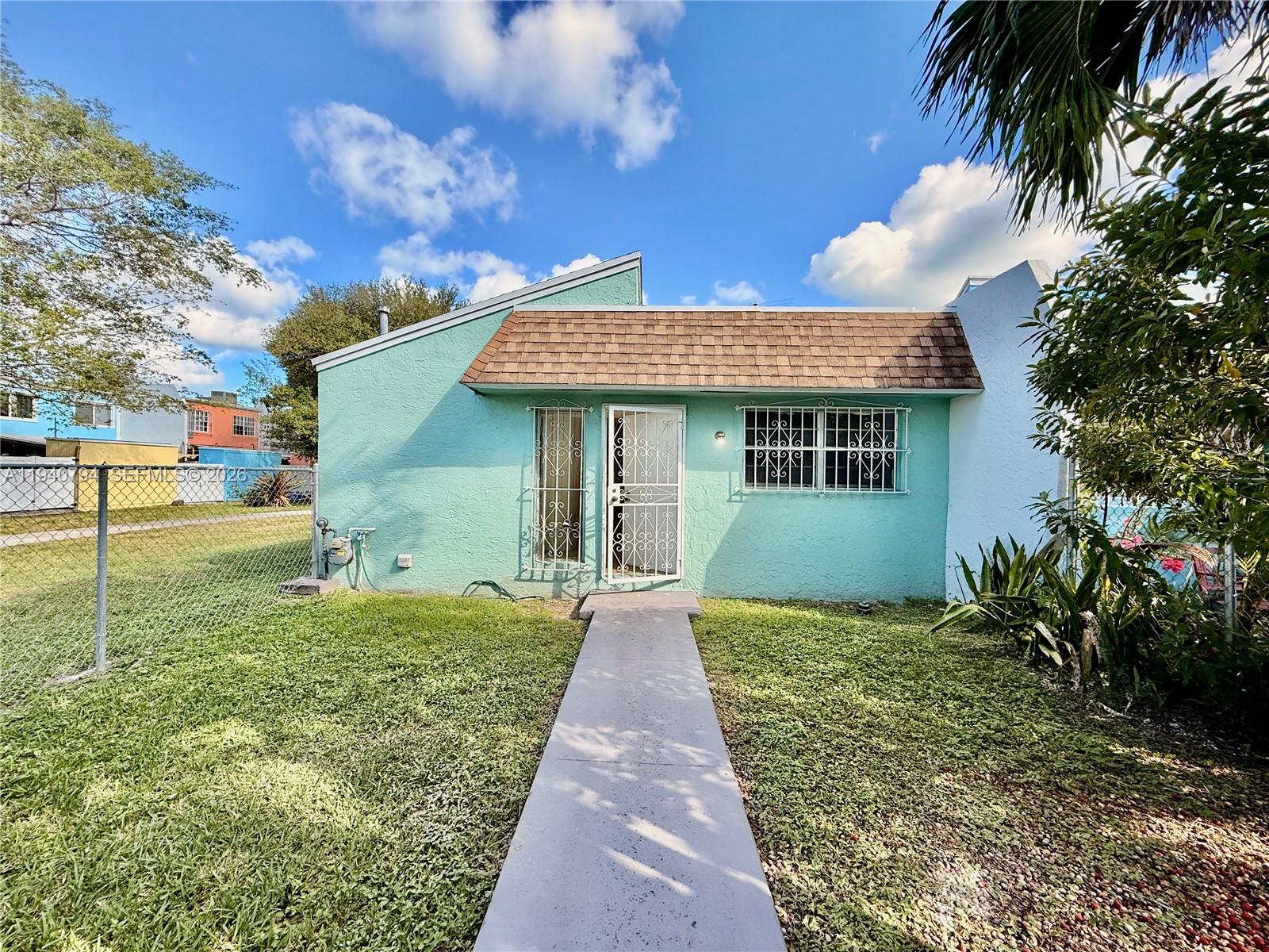 617 Northwest 10th Street Miami, FL 33136 - Photo 18 of 29 a front view of a house with garden
