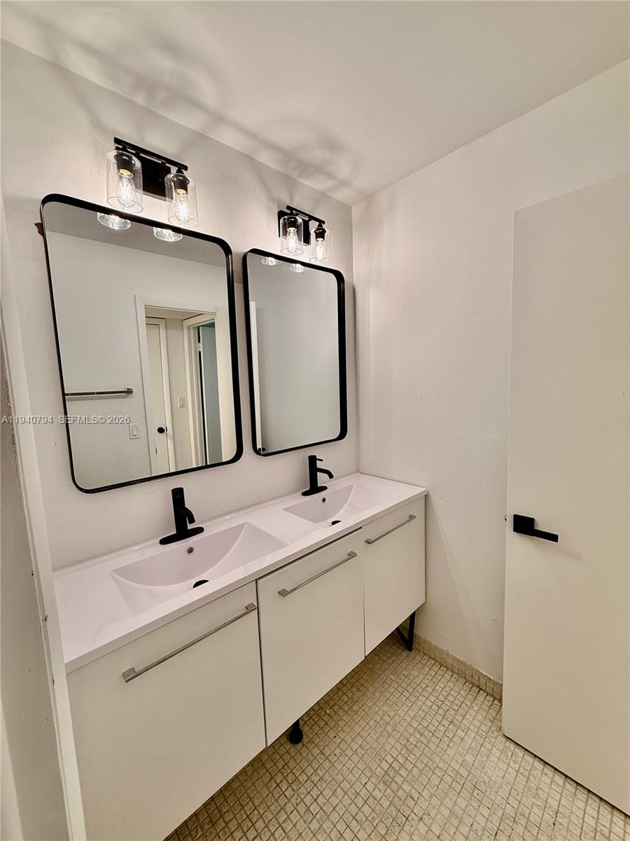 617 Northwest 10th Street Miami, FL 33136 - Photo 19 of 29 a bathroom with a toilet sink and mirror