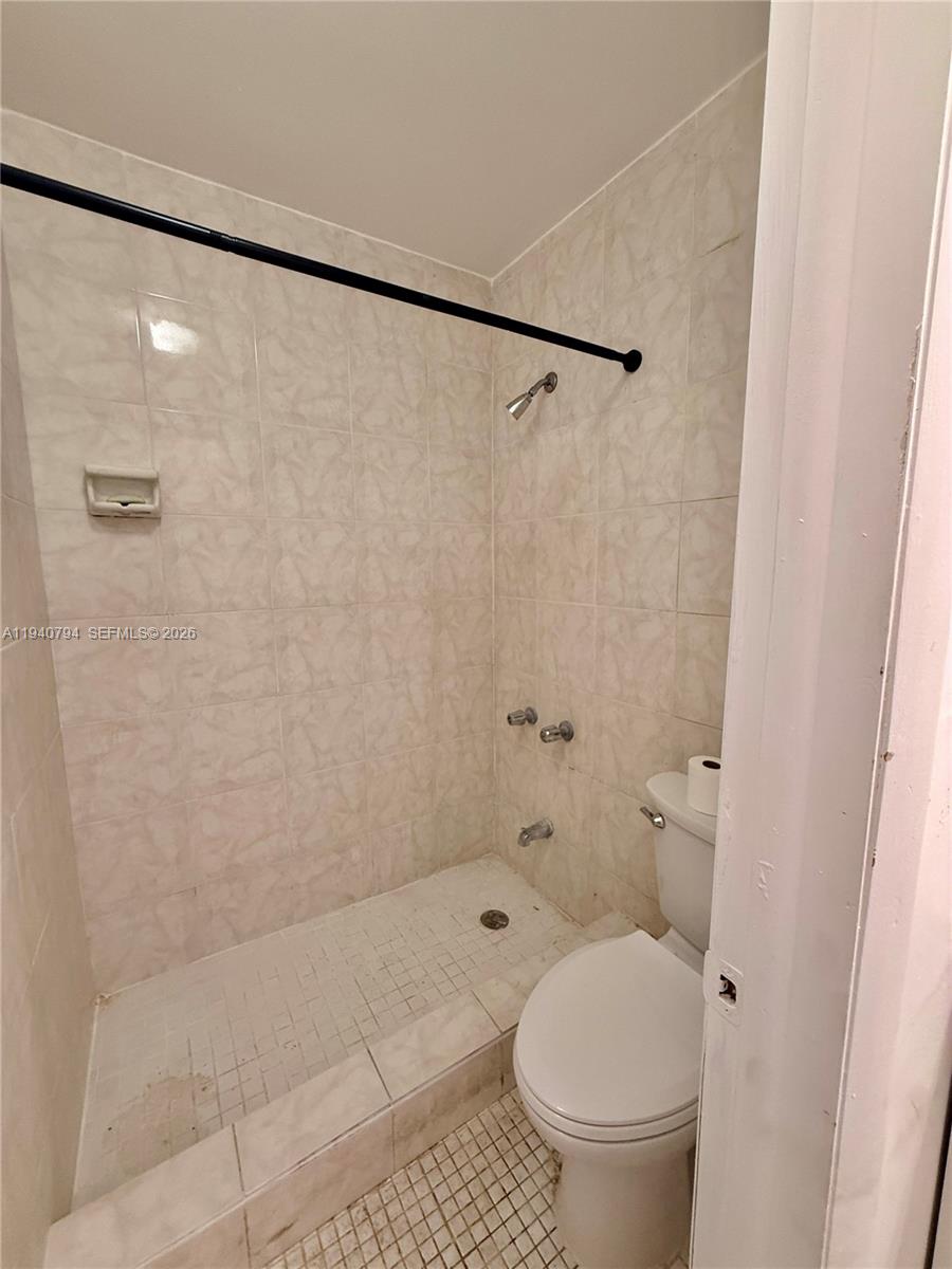 617 Northwest 10th Street Miami, FL 33136 - Photo 20 of 29 a bathroom with a toilet and a shower