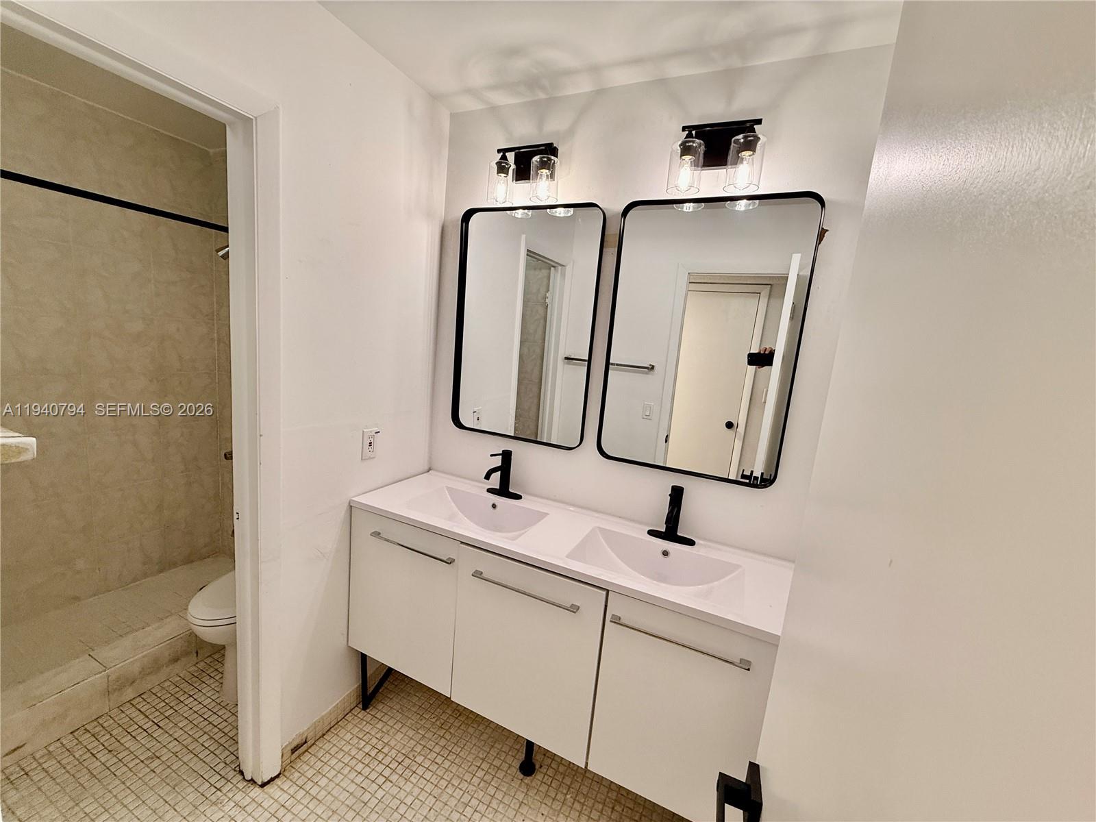 617 Northwest 10th Street Miami, FL 33136 - Photo 21 of 29 a bathroom with a sink and mirror