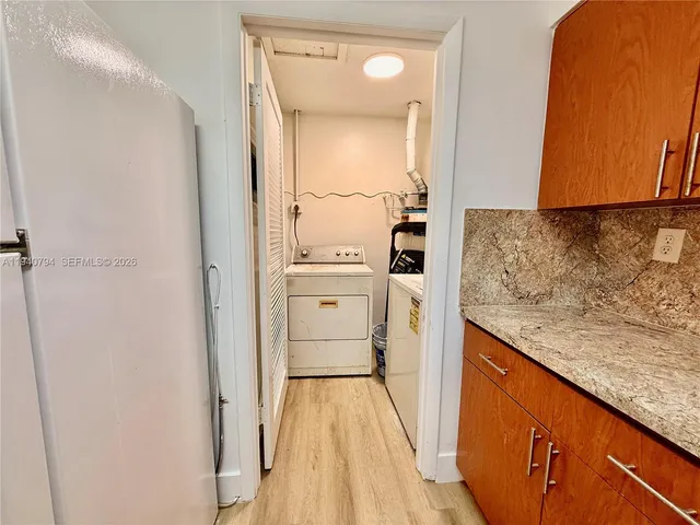 a view of a room with wooden floor and a window