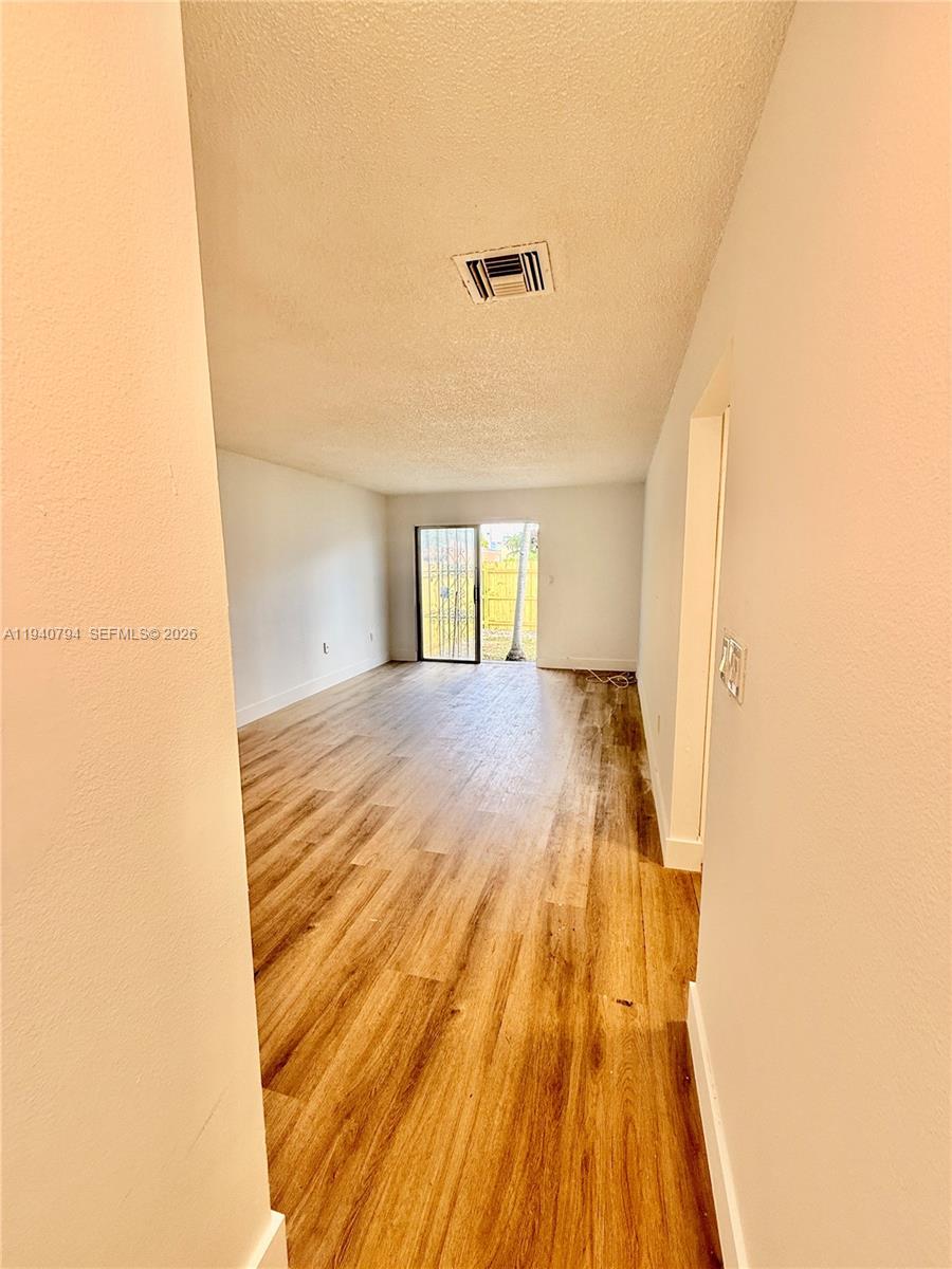 617 Northwest 10th Street Miami, FL 33136 - Photo 23 of 29 a view of a room with wooden floor and a window