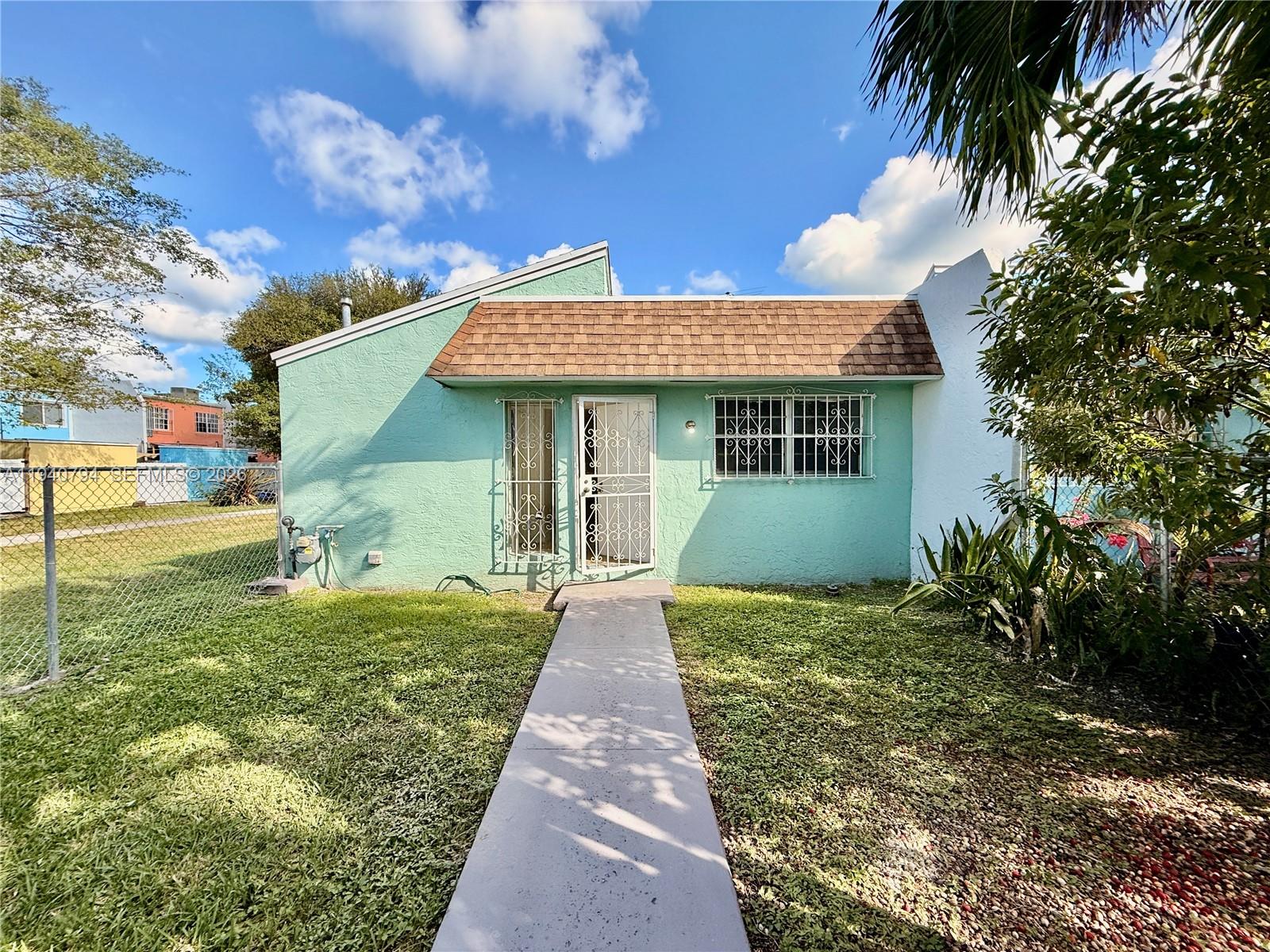 617 Northwest 10th Street Miami, FL 33136 - Photo 24 of 29 a front view of a house with garden