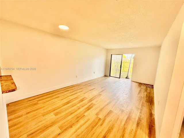 a kitchen with stainless steel appliances granite countertop a refrigerator a stove and a sink with wooden cabinets