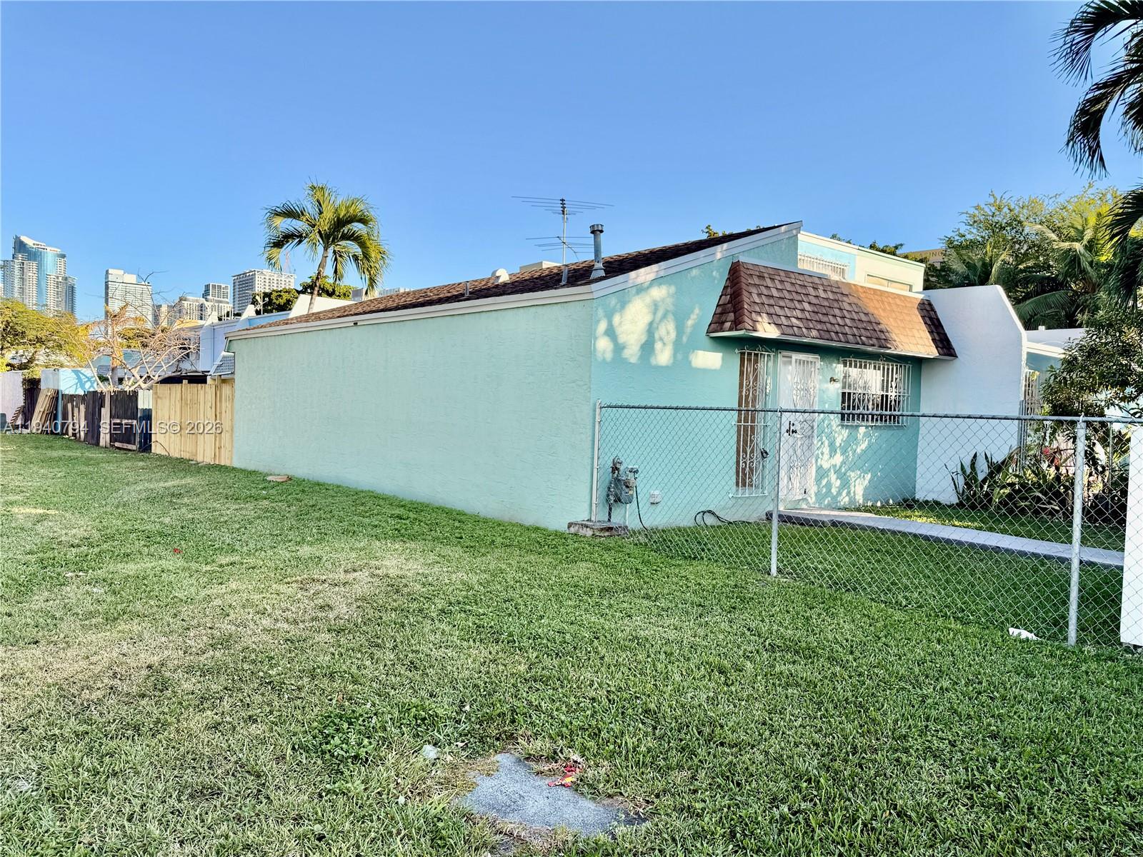 617 Northwest 10th Street Miami, FL 33136 - Photo 3 of 29 a front view of a house with a yard