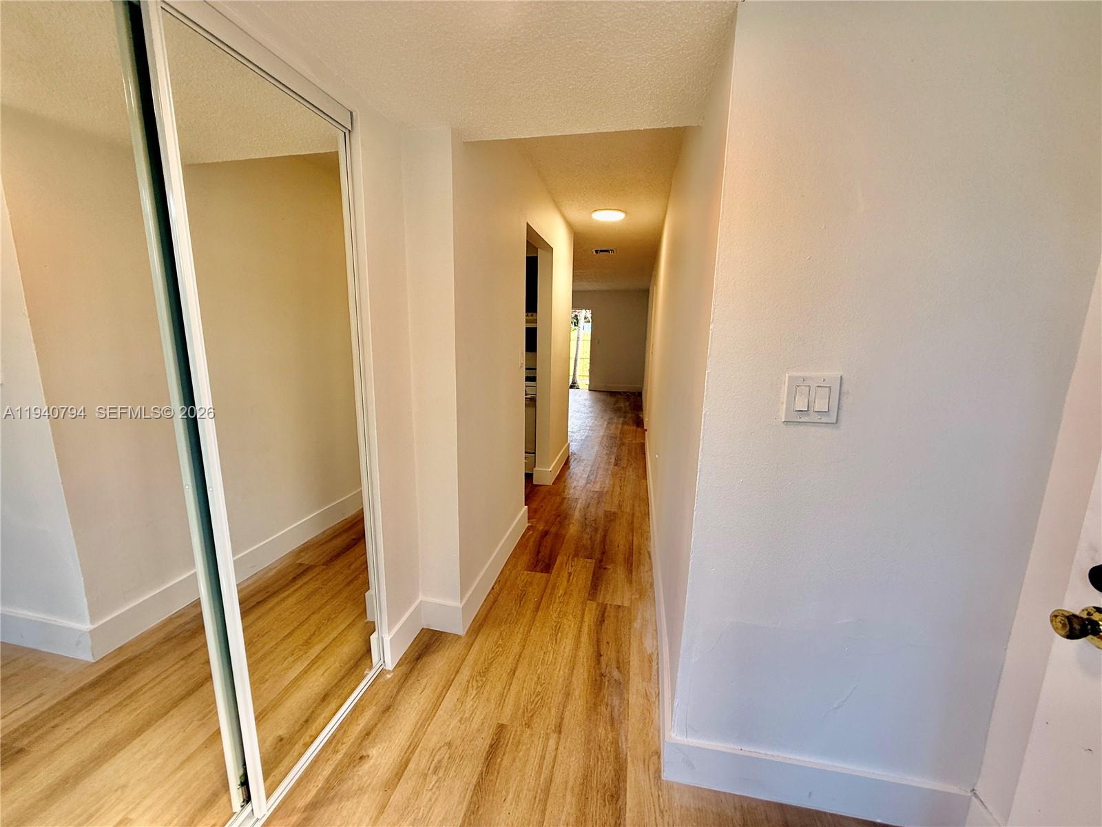 617 Northwest 10th Street Miami, FL 33136 - Photo 6 of 29 a view of a hallway with wooden floor and staircase