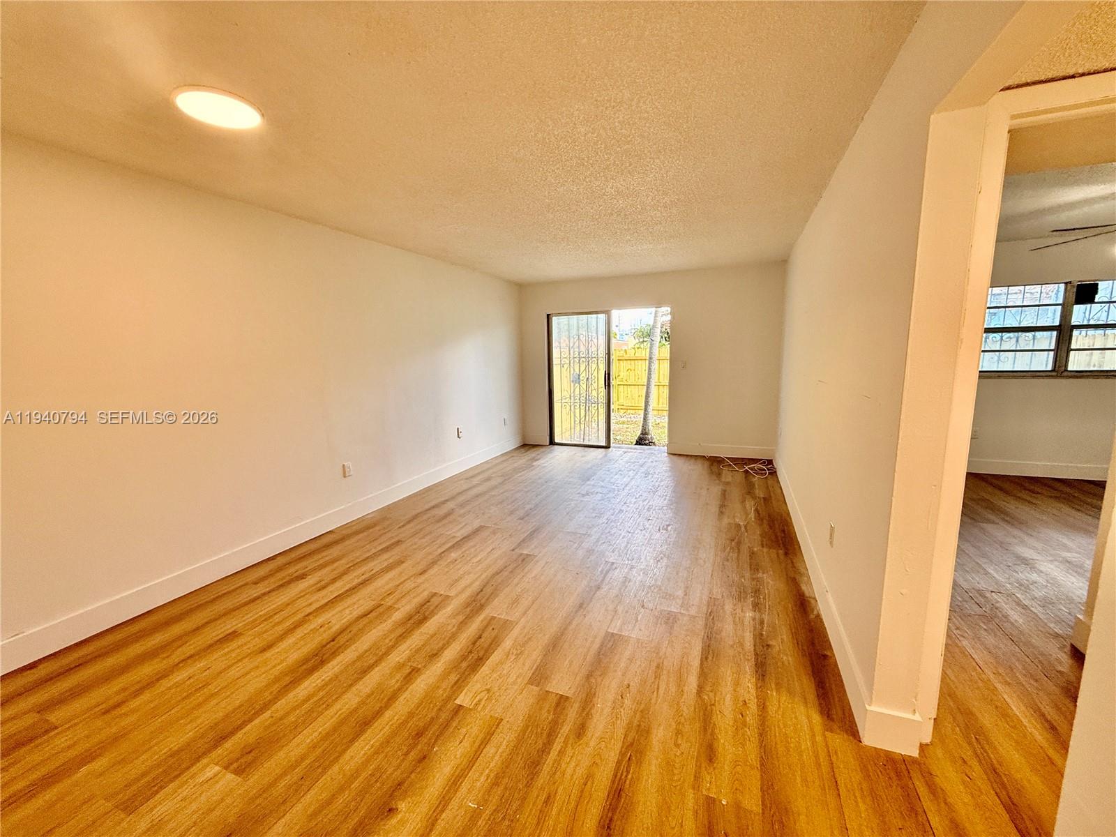 617 Northwest 10th Street Miami, FL 33136 - Photo 7 of 29 a view of a room with wooden floor and staircase