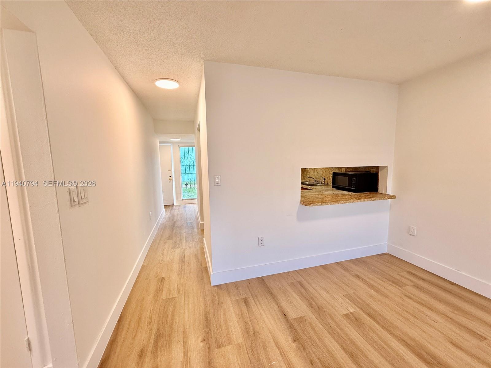 617 Northwest 10th Street Miami, FL 33136 - Photo 8 of 29 a view of a room with wooden floor