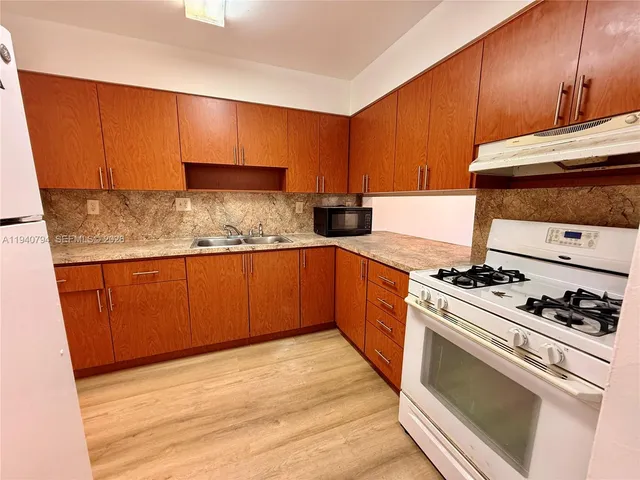 a white refrigerator freezer sitting inside of a kitchen