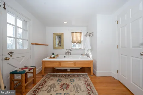 a bath room with a sink and a mirror