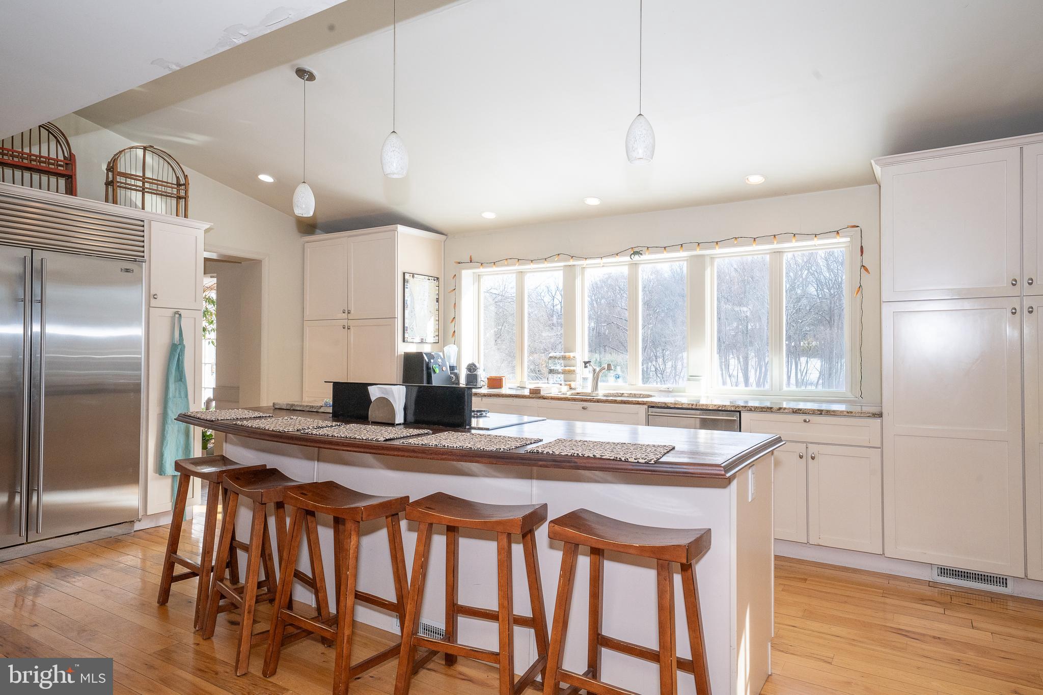 449 Boxwood Road Bryn Mawr, PA 19010 - Photo 6 of 20 a kitchen with granite countertop a sink a center island stainless steel appliances and cabinets