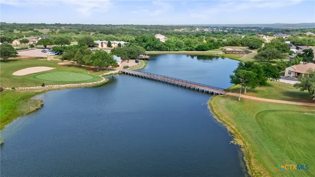 an aerial view of a house with a lake view