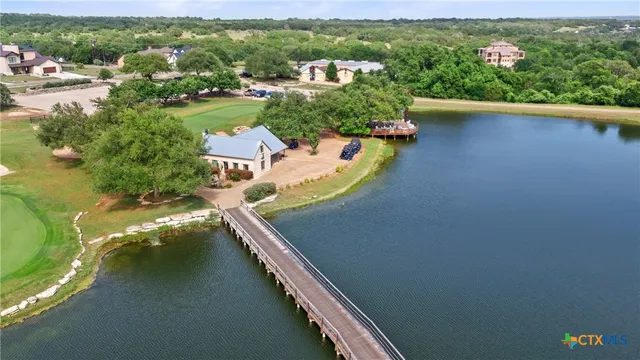 an aerial view of a house with yard swimming pool and outdoor seating