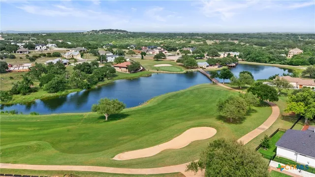 an aerial view of residential houses with outdoor space and river