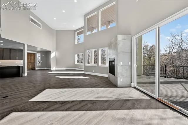 a view of a livingroom with wooden floor and staircase